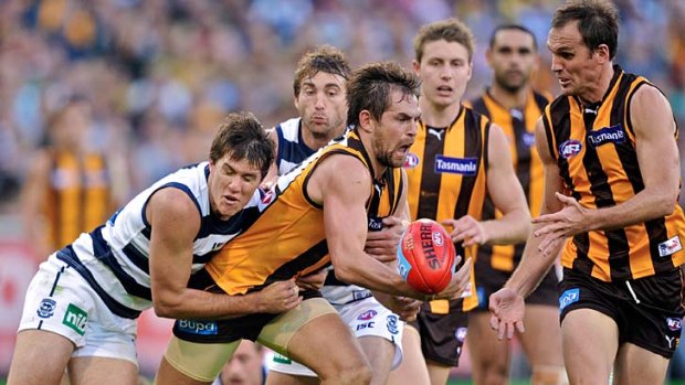 Luke Hodge is tackled by Andrew Mackie during the round 5 clash between Hawthorn and Geelong.
