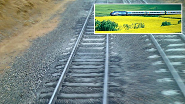 This image of a 'mud hole' on the Melbourne-Sydney line, was provided to The Age after concerns were raised about XPT passenger train (inset) safety.