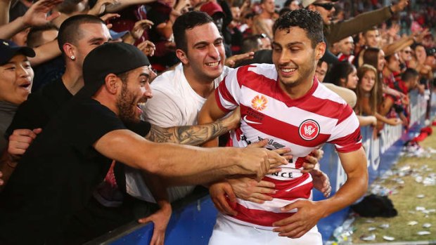 Jubilation: Adam D'Apuzzo celebrated with Wanderers fans after the Sydney derby win over Sydney FC.