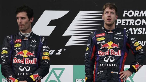 Awkward moment, anyone? Sebastian Vettel and teammate Mark Webber stand on the podium after the Malaysian Grand Prix, which Vettel won after he disobeyed team orders.