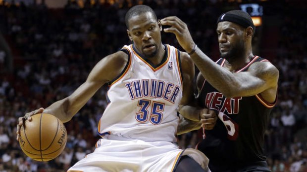 Miami Heat small forward LeBron James puts pressure on Oklahoma City Thunder small forward Kevin Durant.