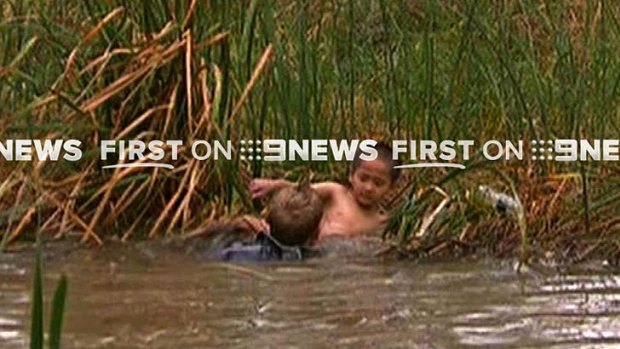 Glenn Edwards rescues Ryan Pham from the creek.