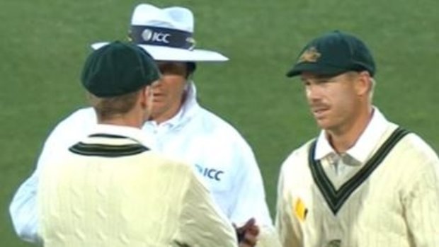 Steven Smith and David Warner have a quiet word with the umpire, but not quietly enough.