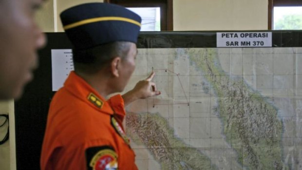 An Indonesia air force officer shows a map of Malacca Straits during a briefing.