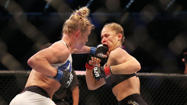 Upset: Holly Holm lands one on the face of Ronda Rousey in their UFC title fight in Melbourne. 