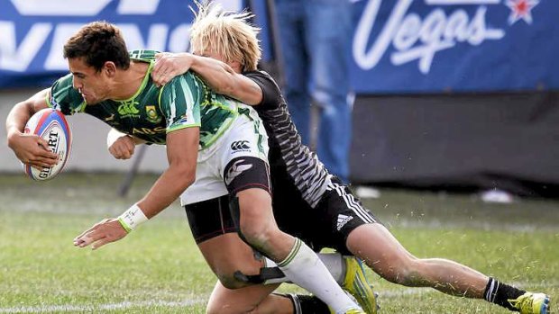 Chris Dry of South Africa is tackled by Warwick Lahmert in New Zealand in the Cup final.