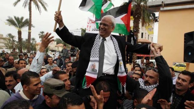 Accusations ... chief Palestinian negotiator Saeb Erekat is carried during a rally upon his return from Cairo to the West Bank city of Jericho, two days ago.