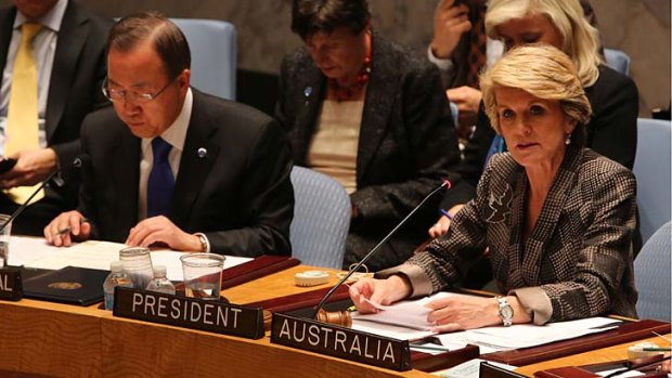 United Nations Secretary-General Ban Ki-moon, left, listens as Australian Foreign Minister Julie Bishop speaks during a Security Council meeting on small arms, at United Nations headquarters.