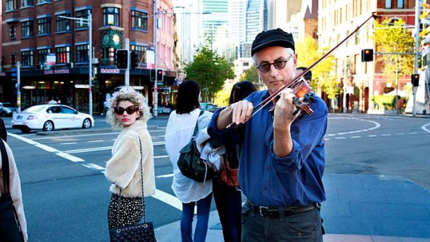 Let the music flow: Jon Rose in an impromptu performance in George Street, Sydney.
