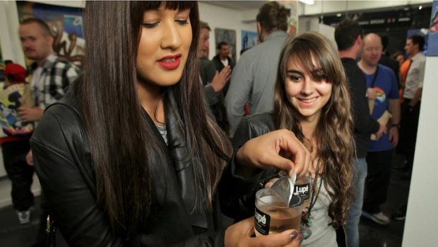 Jess (left) and Ally, guests at a gallery opening in Prahran, sample the new Lupe glasses of wine.