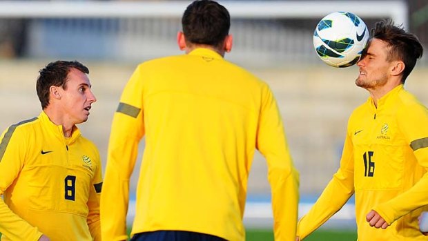 Eye on the ball: James Holland (right) trains with some Socceroo teammates ahead of their crucial World Cup qualifier against Jordan on Tuesday night.