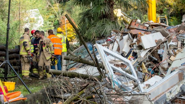 Rescuers at the scene of a landslide  that buried a building in the village of Davesco-Soragno near Lugano, Switzerland on Sunday.