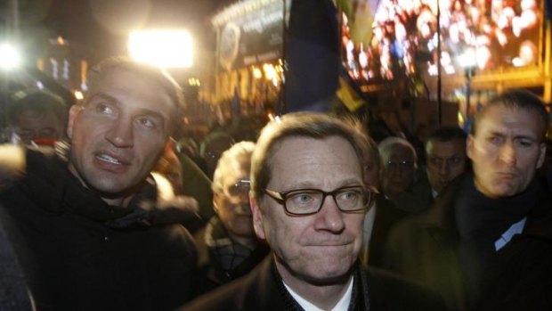 German Foreign Minister Guido Westerwelle (centre) and heavyweight boxing champion and UDAR (Ukrainian Democratic Alliance for Reform) party leader Vitali Klitschko (left) walk along  Independence Square.