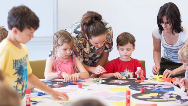 Jemima Wyman with young visitors participating in a children's art centre activity trail at GoMA.