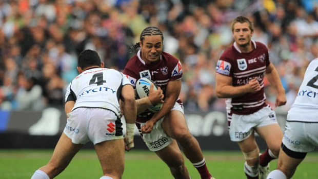 No holding back ... Manly centre Steve Matai takes on Warriors counterpart Krisnan Inu last night in the heat of battle.