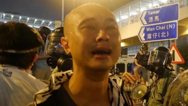 Tears of sadness: Student Leung Hei is overcome with emotion amid the crowds.