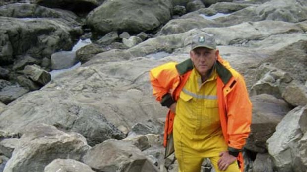 New Zealand Department of Conservation officer Phil Bradfield stands next to several dead seals near Kaikoura on New Zealand's South Island.