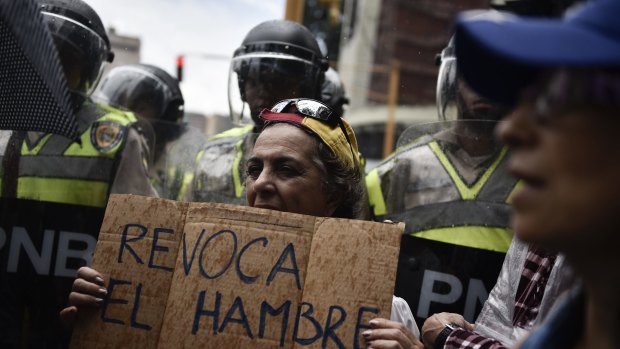A protester holds a sign that reads "Revoke hunger" during a demonstration against Venezuelan President Nicolas Maduro earlier this year.