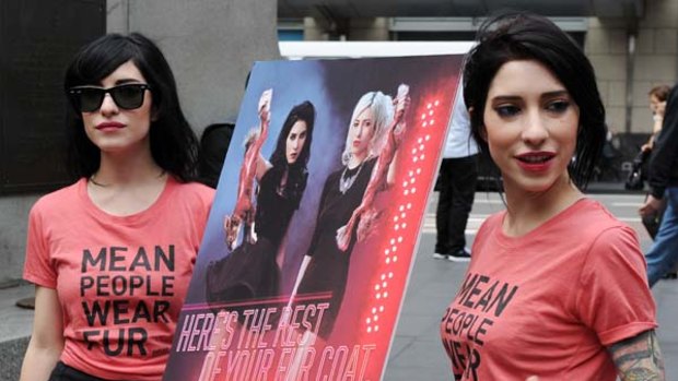 Twin sisters Lisa, left, and Jessica Origliasso, the duo behind the pop-rock band the Veronicas, unveil their new PETA poster  in Sydney.