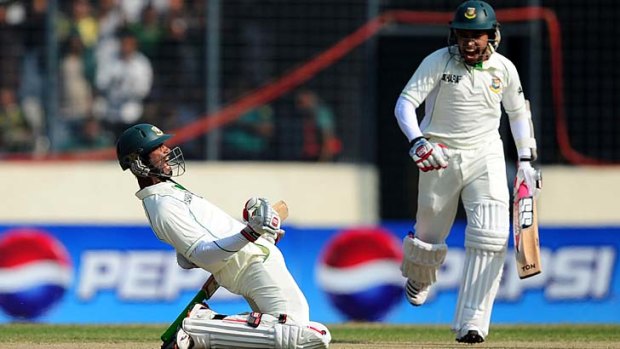 Naeem Islam (left) celebrates after reaching his maiden Test century as teammate Mushfiqur Rahim looks on.
