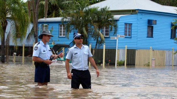As the floodwaters keep on rising, extra police are called in to protect evacuated homes from looters in Rockhampton.