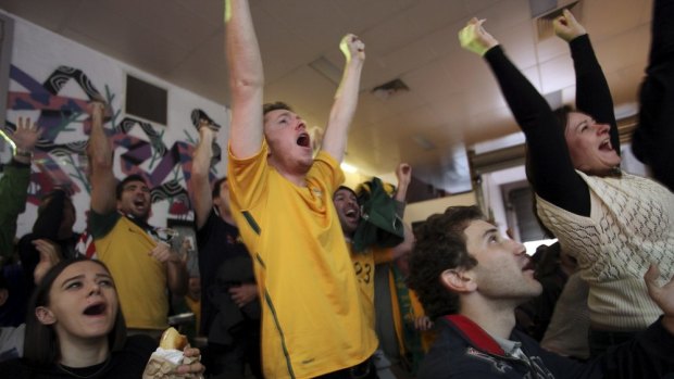 Socceroos fans cheer on their team in Redfern.