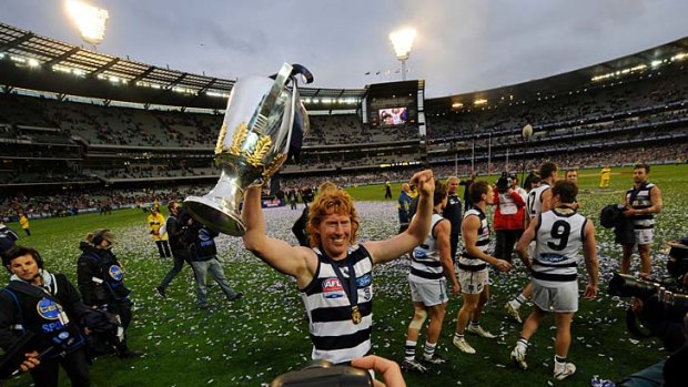 Triumphant Geelong skipper Cameron Ling with the 2011 premiership cup after an almighty win over Collingwood at the MCG yesterday.