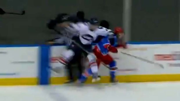 A linesman is crunched between Ice's Chris Frank and North Star Beau Taylor.