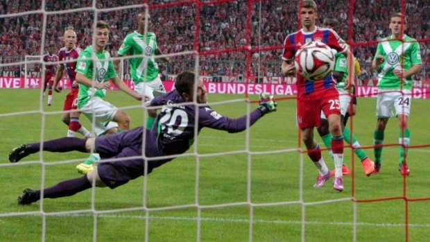Wolfsburg's Max Grun fails to stop Arjen Robben's match-winner for Bayern Munich.