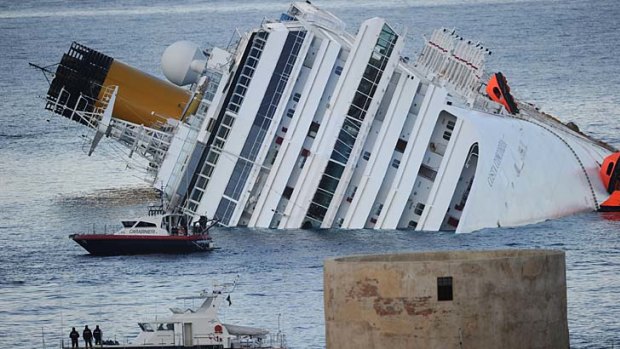 Police and coast guard boats attend the floundering Costa Concordia.
