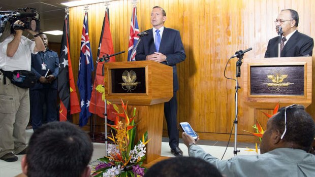 Australian Prime Minister Tony Abbott speaks at a joint press conference with Papua New Guinea's Prime Minister Peter O'Neill.