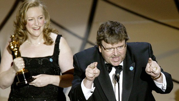 Filmmaker Michael Moore launches a vitriolic attack on then-US president George W Bush for waging war in Iraq.