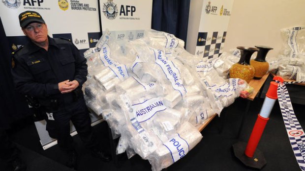 Bagged ... officers keep watch over some of the drugs seized from the shipment of ice and heroin.
