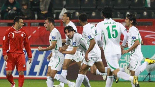 The Iraqi team celebrated an early goal yesterday, but lost 2-1 to Iran, which tops group D.