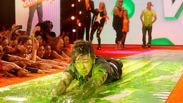 Slime time ... singer Reece Mastin slides in some green goo.