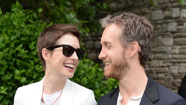 Incredible shrinking woman ... Anne Hathaway and fiance Adam Shulman in New York earlier this month.