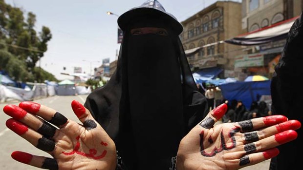 A Yemeni anti-government protester shows her hands bearing the writing in Arabic "We are all Taez (Taiz)" during a demonstration.