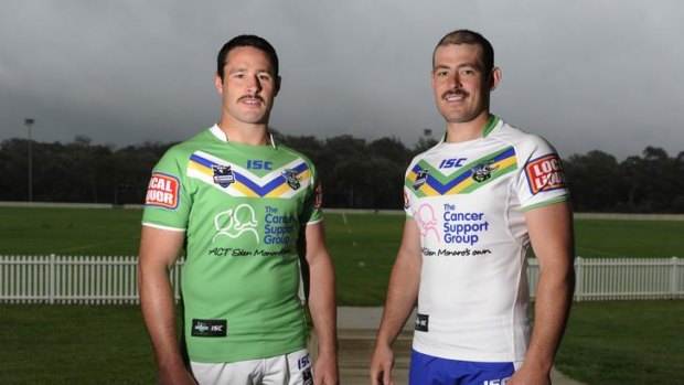 Raiders Brett White and Terry Campese with the Canberra Raiders jerseys for the 2012 season. The Raiders, who are with out a major jersey sponsor, have added the charity The Cancer Support Group on their strip for the coming season.