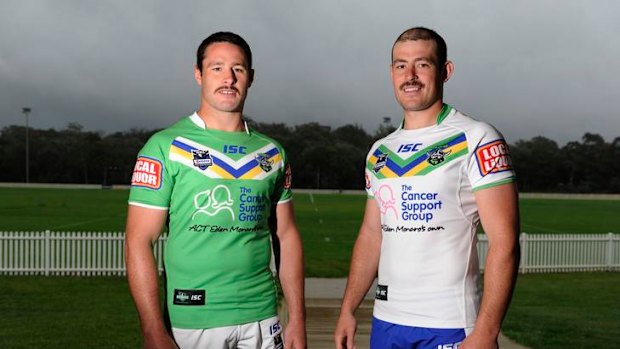 Raiders Brett White and Terry Campese with the Canberra Raiders jerseys for the 2012 season. The Raiders, who are with out a major jersey sponsor, have added the charity The Cancer Support Group on their strip for the coming season.