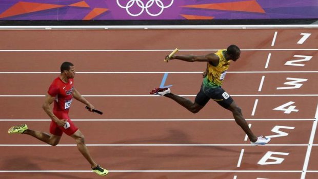 First over the line ... Jamaica's Usain Bolt crosses ahead of Ryan Bailey of the US .