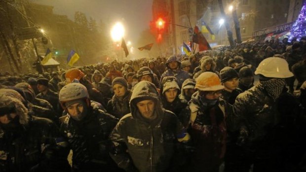 Pro-European Union activists gather next to Ukrainian riot police guarding the Ukrainian Government buildings in Kiev, Ukraine.