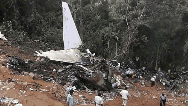 Officials and rescuers at the site of the Air India Express passenger plane crash in Mangalore.