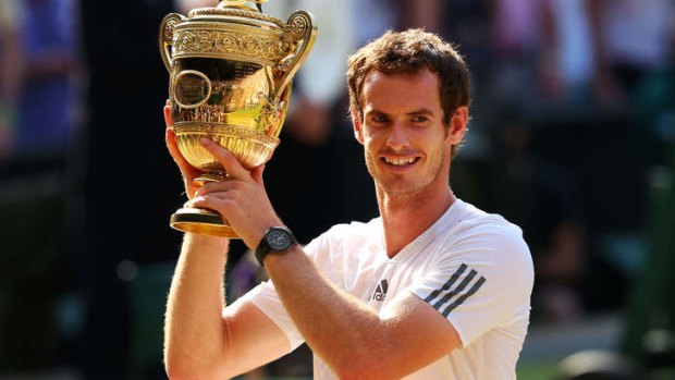 Long wait over: Andy Murray raises the winner's trophy after his straight-sets victory.