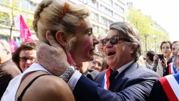 Political alliance: the anti gay marriage activist "Frigide Barjot" embraces National Front MP Gilbert Collard at a demonstration against the bill.