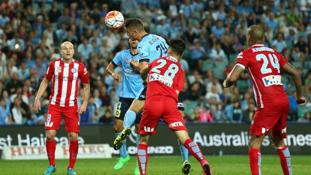 Head to head: Sydney FC’s George Blackwood deflects the ball against Melbourne City on Saturday.