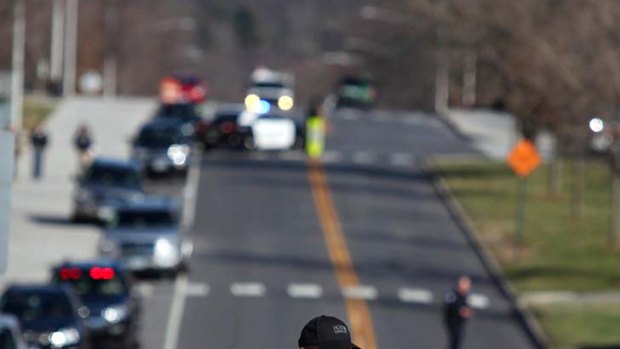 Killer on the loose ... police officers block a road on the Virginia Tech campus.