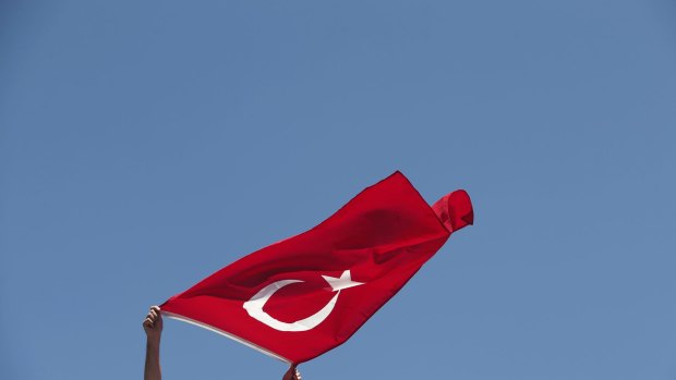 A pro-government supporter waves a Turkish flag during a protest against the attempted coup, in Istanbul.
