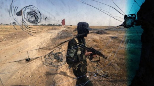 An Iraqi soldier guards a checkpoint in the northern city of Tuz Khurmatu, close to areas occupied by jihadist Islamic State of Iraq and the Levant (ISIL) fighters.