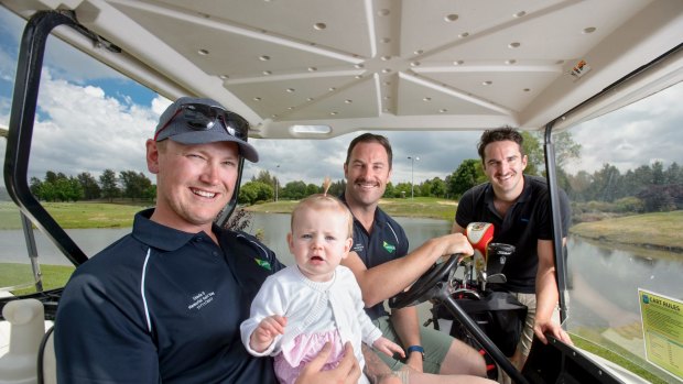 Zach Douglas, ten-month-old Audrey Douglas, celebrity Movember ambassador Sasha Mielczarek, and Movember campaign manager Ben O'Connell at the Stevie D Memorial Golf Day in Canberra on Friday.