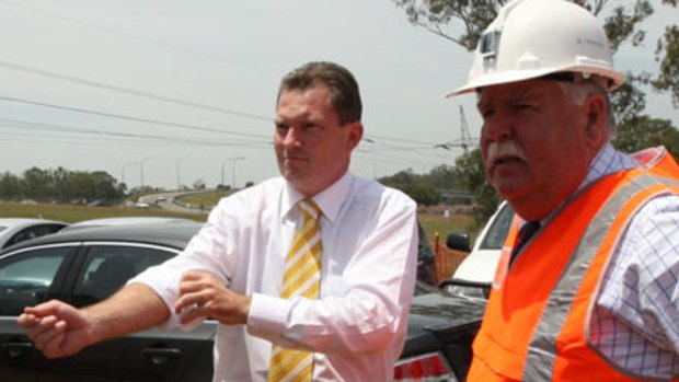Rolling up his sleeves ... Nathan Rees and the Transport Minister, David Campbell, at a railway building site in Glenfield.